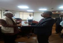 Prof. Oommen presenting book to Justice H.L. Dattu